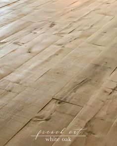 an empty wooden floor with white oak in the middle and light colored paint on it