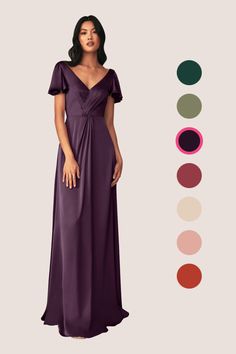 a woman in a long purple dress standing next to an assortment of color swatches