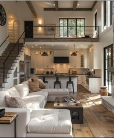 a living room filled with furniture and a fire place in front of a kitchen area