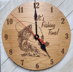 a wooden clock with the words it's fishing time and a fish on it