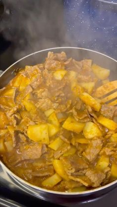 the food is being cooked in the pot on the stove