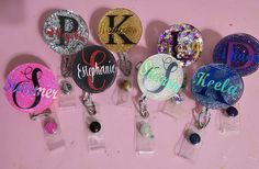 Beautiful personalized badge reels to add bling to your scrubs, shirt pocket, belt loop, and lanyard. A great gift choice for nurses, teachers, office staff and anyone needing to wear a badge. Larger letter features a silver holographic vinyl.Specifics:--1.5" acrylic blank--Hand glittered and sealed with Epoxy for added protection against wear and tear--Retractable badge reel with clipPlease indicate your personalization preferences in the notes to seller field. No cancelations once order has be Customizable Black Badge Reel, Personalized Black Badge Reel For Personal Use, Personalized Adjustable Black Badge Holders, Personalized Black Lanyards For Gifts, Personalized Black Lanyard For Gift, Personalized Black Lanyards As Gift, Personalized Multicolor Badge Holders For Everyday Use, Personalized Multicolor Badge Holders, Customizable Multicolor Badge Reel For Gift