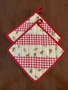 two red and white checkered bibs on a wooden table