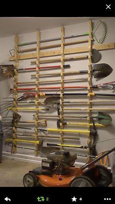 an image of a garage with tools hanging on the wall and lawn mowers