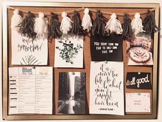 a bulletin board with some cards and tassels hanging from it's sides