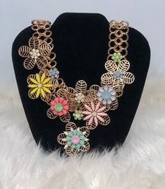 Statement Necklace with flower accents in various colors. Spring Flower Shaped Jewelry With 3d Flowers, Spring Flower Jewelry With 3d Flowers, Multicolor Flower Shape Jewelry For Party, Spring Jewelry With 3d Flowers, Multicolor Flower Necklace For Spring Gift, Multicolor Flower Necklace As Spring Gift, Multicolor Flower Decorated Jewelry For Spring, Multicolor Party Jewelry With Flower Shape, Spring Chic Jewelry With Flower Decoration