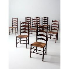 six wooden chairs with woven seat cushions