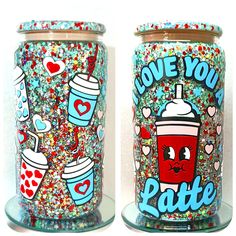 two glass jars with different designs on them, one is filled with confetti and the other has sprinkles