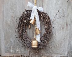 a wreath with bells hanging on a wooden door