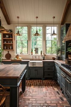 a kitchen with brick flooring and lots of windows