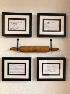 three black and white framed pictures hanging on the wall with two knives in front of them