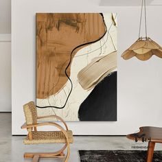 an abstract painting hangs on the wall next to a rocking chair