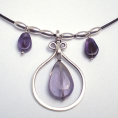 "Sterling silver, amethyst teardrops and sterling melon beads combine in this lyrical necklace. A subtle combination of textures draws the eye; your throat becomes the center of attention...  Center pendant is approx. 1.5\" long. Strung on a supple black leather cord, about 14\" long, plus a 2\" sterling chain extender. Hand-formed sterling hook closure.  Amethyst is the birthstone for February. Amethysts are commonly believed to hold powers over dreams, peace, healing, love, courage, spiritual uplifting, and a general overall happiness. And who can resist that luscious purple color?" Texture Drawing, Sterling Necklaces, Chain Extenders, Richmond Va, Leather Cord, Melon, Purple Color, Birthstone, Necklace Etsy