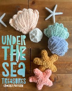 four crocheted seashells and one starfish on a wooden surface with the words under the sea treasures written below