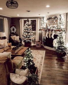 the living room is decorated for christmas with stockings and garlands on the fireplace mantel