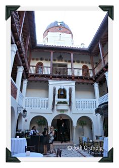 people are standing in the courtyard of an old building