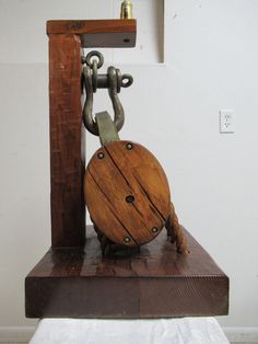 a wooden clock with chains attached to it