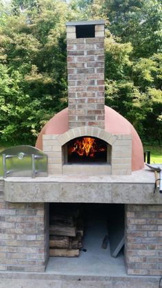 an outdoor brick pizza oven with fire in it