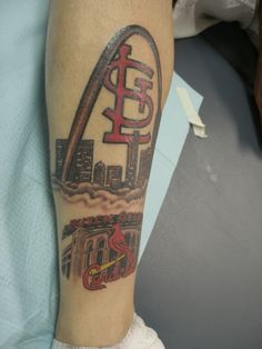 a man with a tattoo on his arm has a st louis cardinals logo in front of the arch