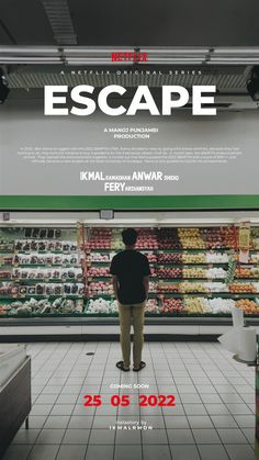 a man standing in front of a poster for the movie escape