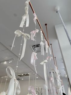 ribbons and bows hang from the ceiling in an office building, decorated with white ribbon