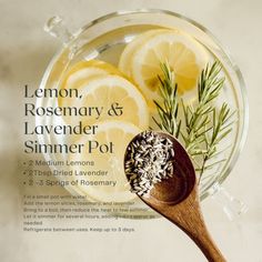 lemons, rosemary and lavender sit in a glass bowl next to a wooden spoon