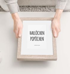 a person holding up a framed photograph with the words halloween popocien in it