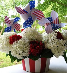 a patriotic flower arrangement in a red, white and blue vase