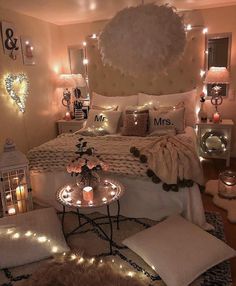 a bedroom decorated with lights and pillows