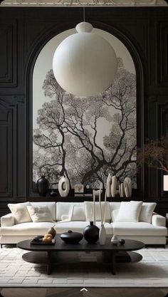 a living room with black and white furniture in the center, an art work on the wall