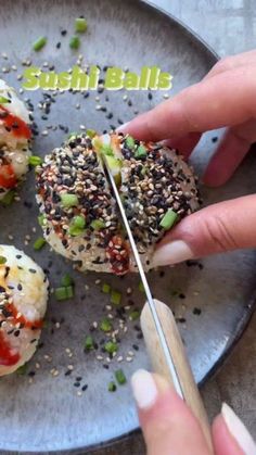 someone is cutting up some kind of food on a plate with chopsticks and sesame seeds