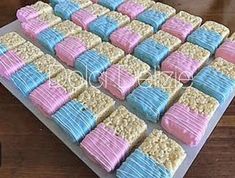 there is a cake made to look like rice krispy treats on a tray with pink and blue frosting