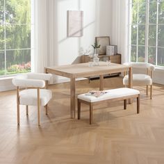 a dining room table with two chairs and a bench in front of it on a hard wood floor