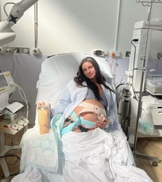 a pregnant woman laying in a hospital bed