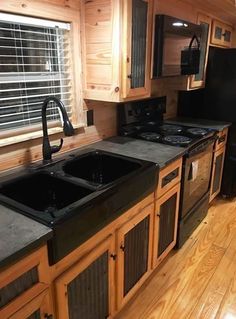 a kitchen with wooden cabinets and black appliances