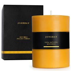 a yellow candle next to a black box on a white background with the words, joneray re - way pillar candle