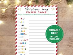 christmas song emoi game with red and white striped paper on wooden table next to lights