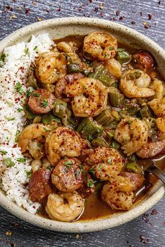 a bowl filled with shrimp, green beans and rice