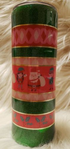 a green and red cup with christmas designs on it