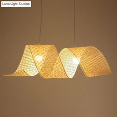 three lights that are hanging from strings in a room with brown walls and flooring