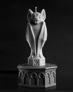 a cat statue sitting on top of a table