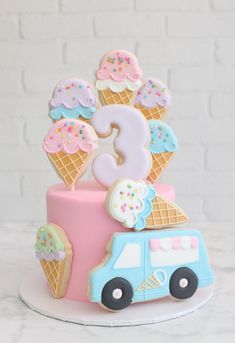 a birthday cake with ice cream cones and numbers on top, decorated in pastel colors