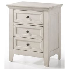 a white nightstand with three drawers on it