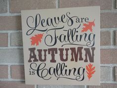 there is a sign that says leaves are falling autumn is coming on the brick wall