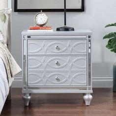 a nightstand with a clock on top of it