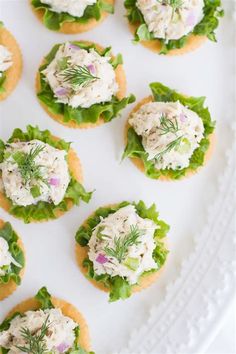 small appetizers are arranged on a white platter