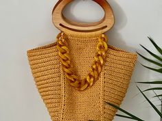 Crafted with quality materials, the raffia Ispie bag in turmeric tone adds a unique touch to your ensemble. Featuring wooden handles, this accessory brings charm to your stylish look. Trendy Yellow Straw Bag With Braided Handles, Chic Yellow Rectangular Straw Bag, Chic Yellow Straw Bag For Daily Use, Chic Yellow Straw Bag For Everyday Use, Chic Yellow Straw Bag For Everyday, Chic Gold Shoulder Bag With Bamboo Handle, Chic Yellow Rectangular Crochet Bag, Yellow Top Handle Straw Bag For Beach, Chic Yellow Crochet Tote Bag