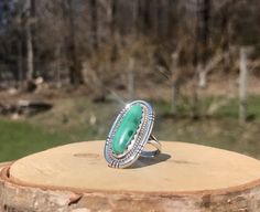 Vintage Navajo Banded Malachite Silver Ring - Long Oval Green Cabochon Ring - Everyday 925 Ring - Signed M. Benally Ring - WhistlingGypsyVTG Stone Size: 23 x 9mm Face: 1.160 x .630" Shoulder Width: .220" Base Width: .100" Size: 6.25 Stamped: "Sterling M Benally" Handcrafted from sterling silver, this vintage Navajo ring holds an oval green malachite cabochon. The stone is a silky green with lace banding in a deeper hue. Nestled in a scalloped bezel, the stone is embraced by a roped border and accented by an artfully cut frame. Split shoulders support the face and gently taper to one solid band at the base. The piece has a nice weight, not too heavy or light and feels very comfortable on the finger! If you have any questions please don't hesitate to ask and thanks for looking! More vintage Bohemian Oval Cabochon Ring, Bohemian Sterling Silver Oval Cabochon Rings, Bohemian Style Adjustable Oval Emerald Ring, Bohemian Oval Emerald Ring Adjustable, Bohemian Green Oval Cabochon Ring, Handmade Bohemian Oval Emerald Ring, Handmade Oval Emerald Bohemian Ring, Bohemian Oval Emerald Anniversary Ring, Artisan Oval Cabochon Ring