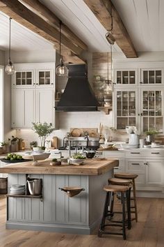 a large kitchen with wooden floors and white cabinets, an island in the middle is surrounded by stools