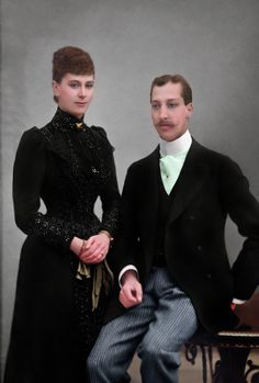 a man and woman dressed in formal clothing